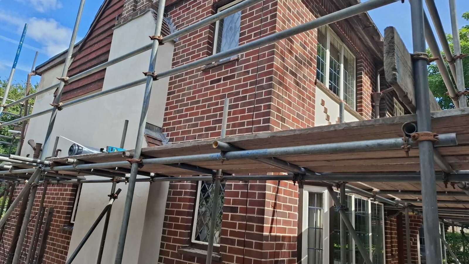 Decorative diamond brick panel set into rendered infill on a 1930s mock Tudor property in Manchester