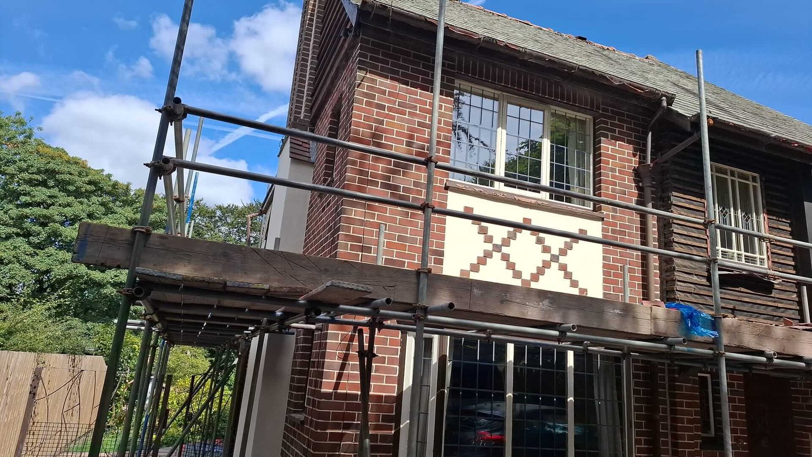 Brick repair and render preparation at first floor level on a 1930s property in Manchester
